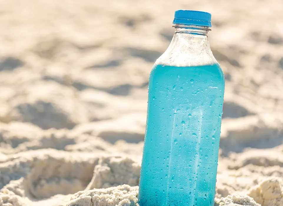 bright blue drink in sand