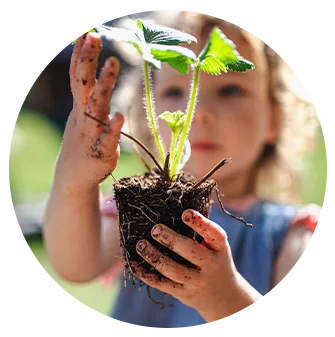 little girl holding a plant