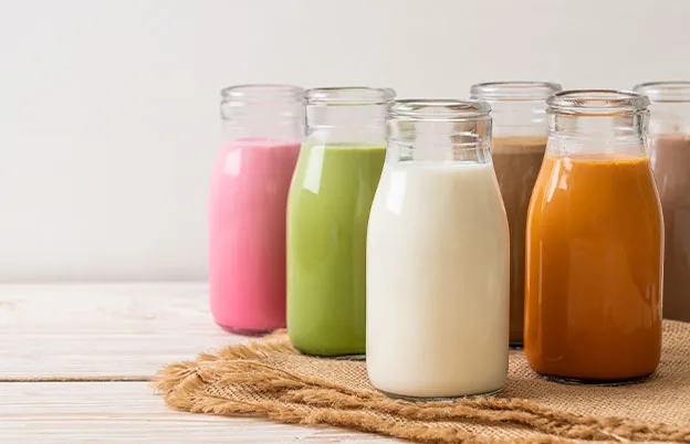 glass jars filled with colorful milk